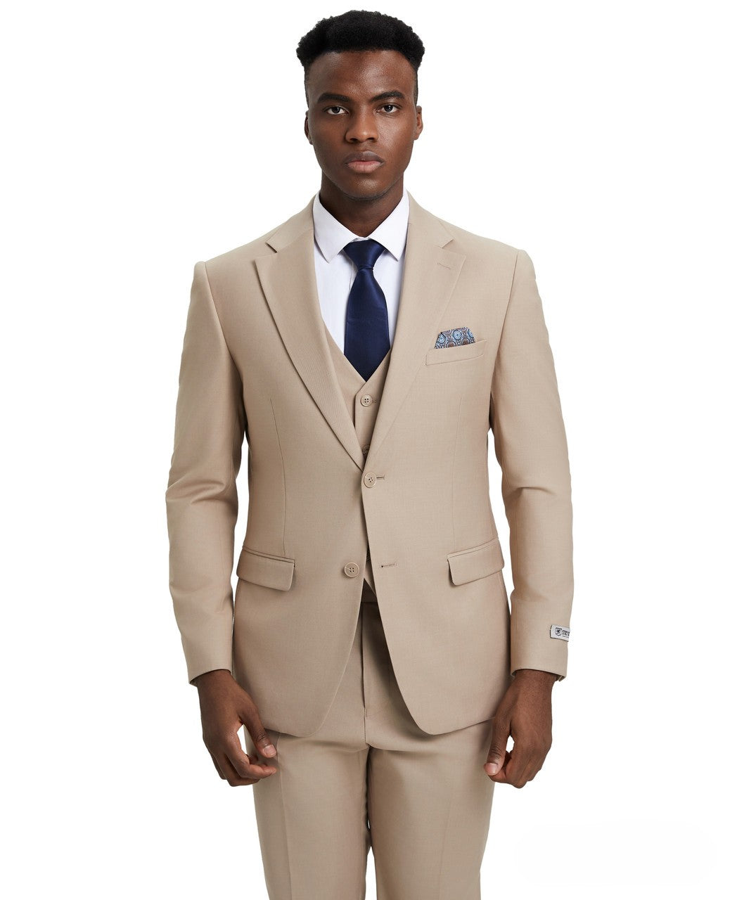 Man wearing a beige suit with a blue tie and pocket square on a white background